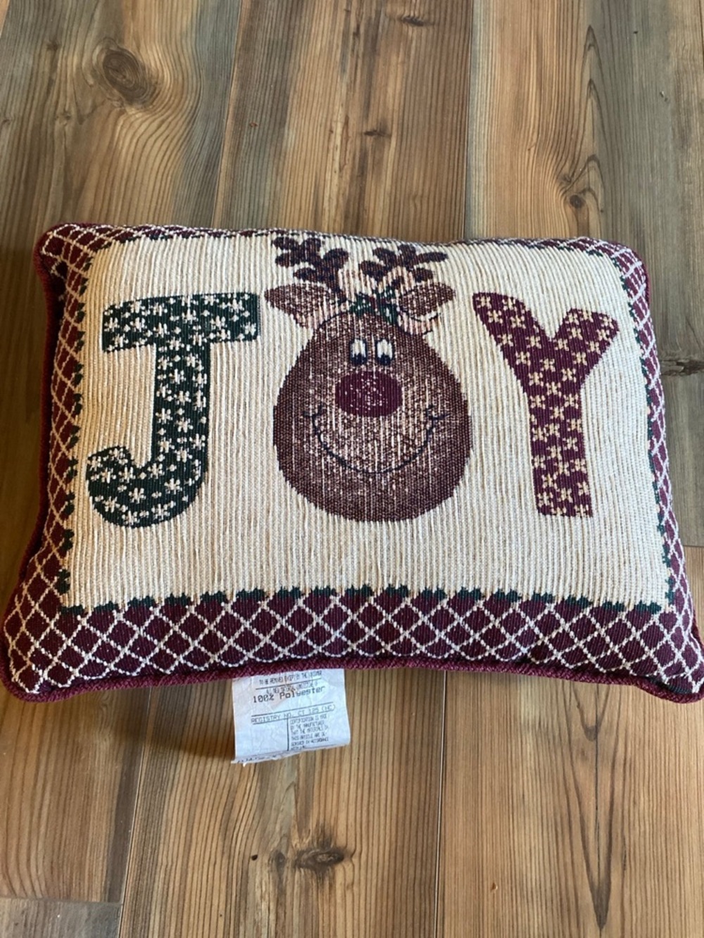 Vintage Christmas tapestry accent pillow featuring a reindeer & the word "JOY”